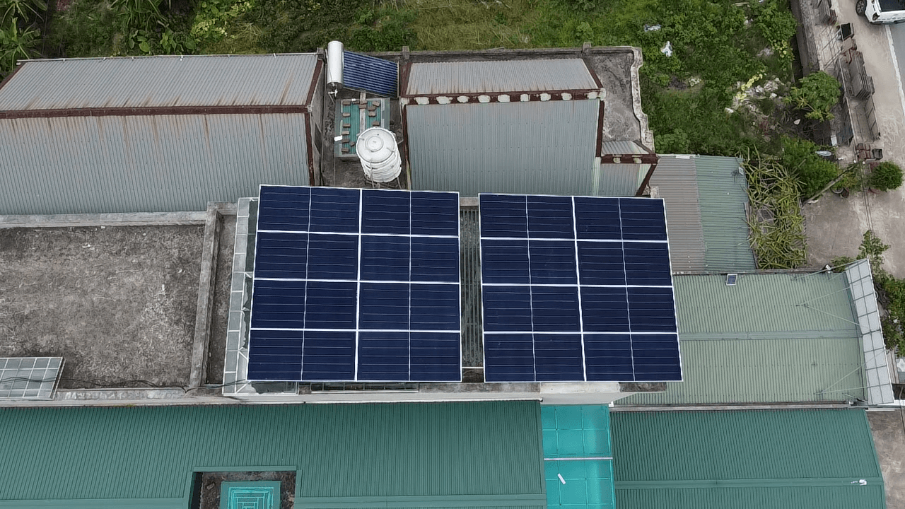 Happy family in front of solar home